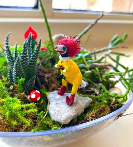 Toy dinosaur painted like a clown