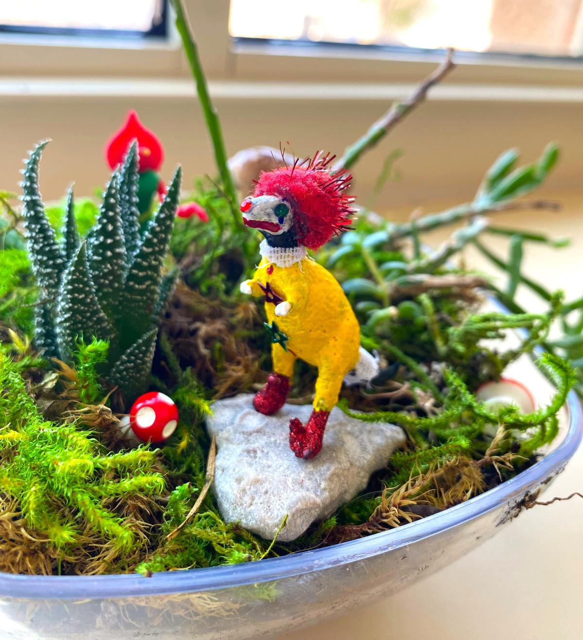 Toy dinosaur painted like a clown