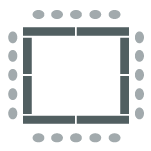 Tables arranged in a square formation with chairs on the outside. 
